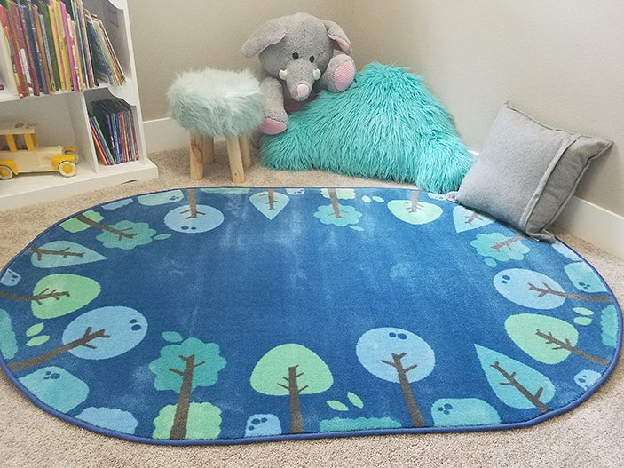 https://www.carpetsforkids.com/wp-content/uploads/2016/12/KIDSoft-Tranquil-Trees-Blue-Oval-Room2.jpg